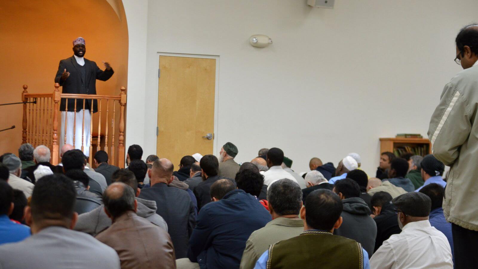 Imam Shafi Abdul Aziz, left, of the the Islamic Center of New Mexico in Albuquerque, speaks on the importance of tolerance during afternoon prayer Friday, Dec. 11, 2015. A coalition from Albuquerque's Christian and Jewish communities presented the Albuquerque mosque dozens of "letters of support" after GOP presidential candidate Donald Trump advocated the U.S. place a moratorium on Muslim immigration. (AP Photo/Russell Contreras) 