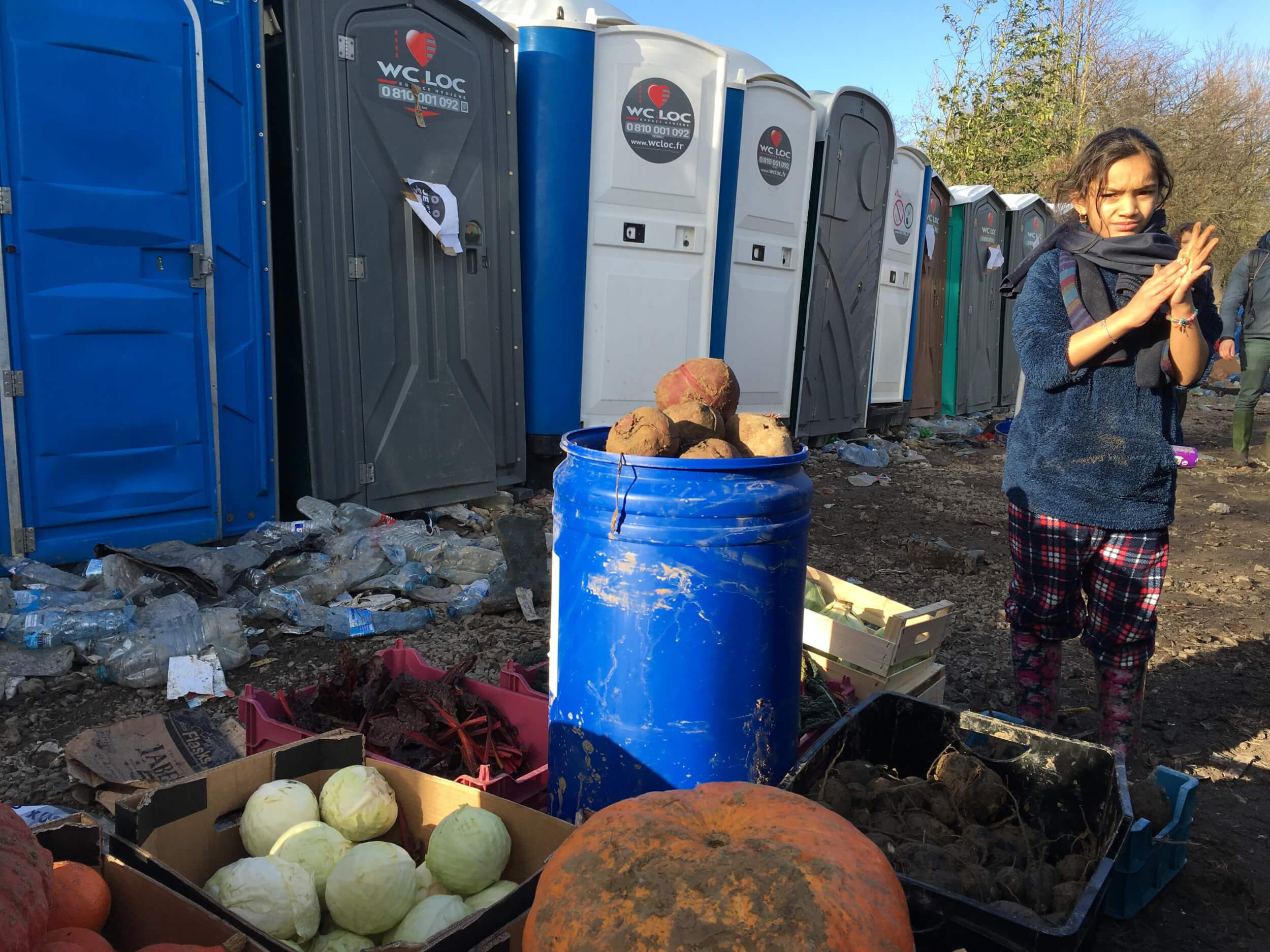 Provisions provided by locals are stocked up next to the port-a-potties of Grande-Synthe. Many volunteers in neighboring U.K. and Belgium arrive in Dunkerque to provide aid during the weekend when refugees will sometimes frantically stock up as the donations can slow to a trickle during the week. (Photo: Katherine Schwartz)