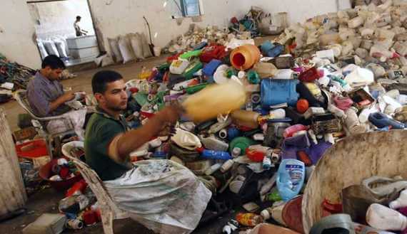 Palestinian laborers sort plastic containers before they are recycled in a factory in Abasan in the southern Gaza Strip (Photo: REUTERS/Ibraheem Abu Mustafa)
