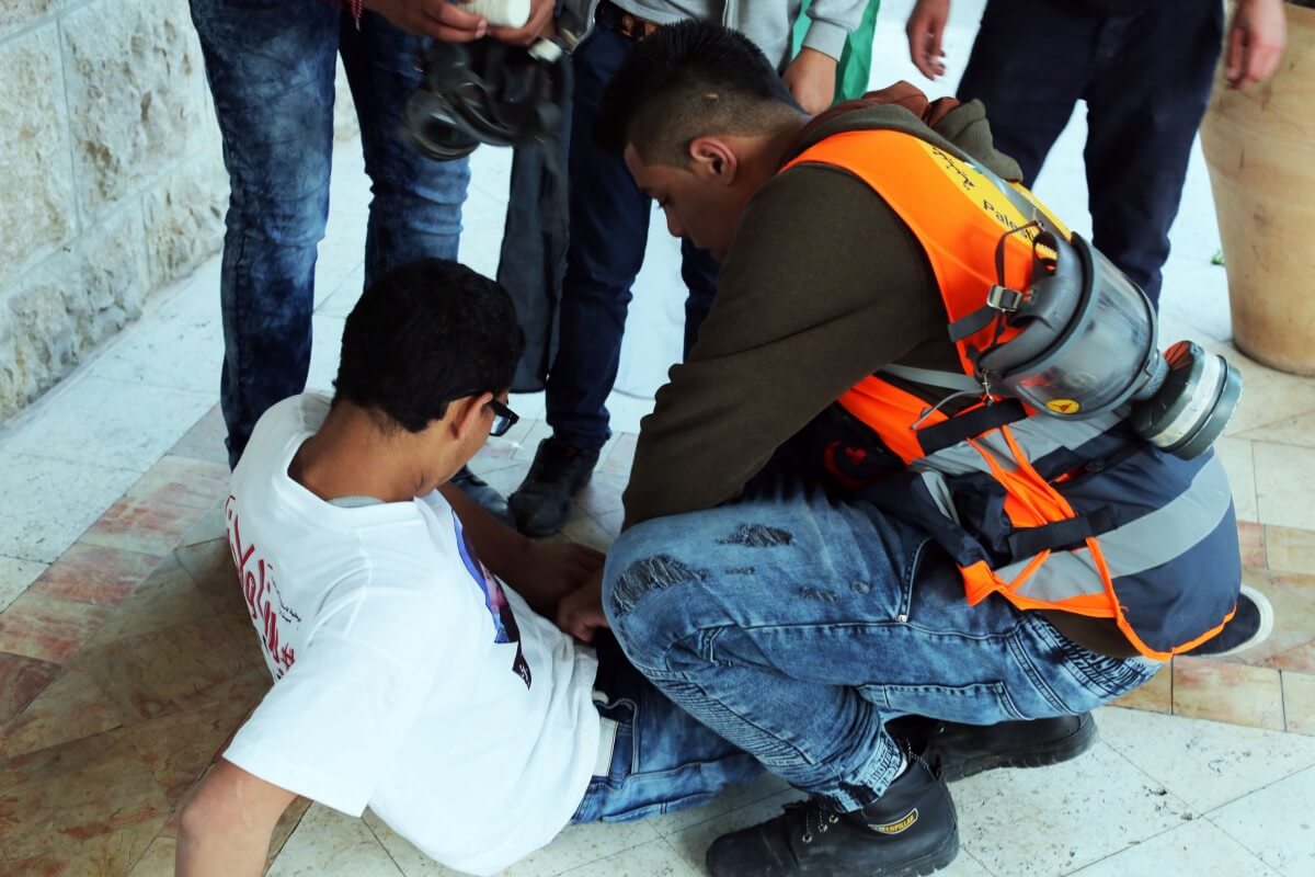 Medics rushed to one young man who was shot with a rubber-coated steel bullet in the leg. (Photo: Abed al Qaisi/Mondoweiss)