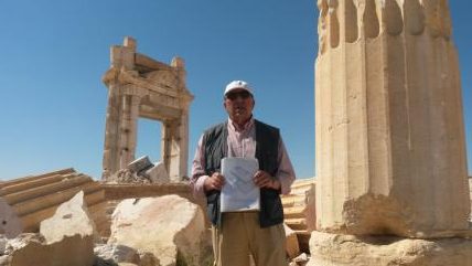 Tour guide “Tony” in front of the ruins of the Temple of Baal blown up by Daesh’ He’s holding a drawing of the temple as it used to appear.