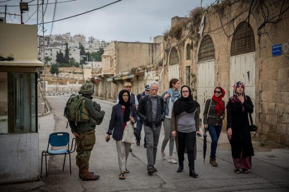 HEBRON, PALESTINE - MAY 24: Festival participants walk through an area of the city inhabited by Israeli settlers on May 24, 2016 in Hebron, Palestine. (Rob Stothard for The Palestine Festival of Literature) 