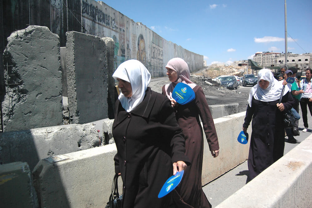 Palestinian women cross Qalandia checkpoint after Israel eases travel, restrictions on worship. (Photo: Allison Deger)