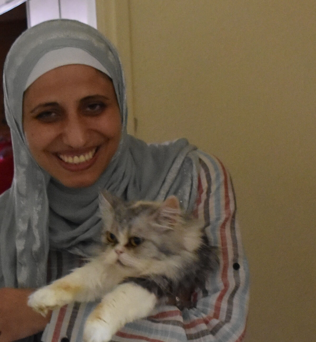 Dareen Tatour with one of her cats. (Photo: Zahi Khamis)