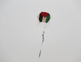 Palestinian children fly a kite with colours of the national flag at the site of protest tents next to the Gaza Strip's border fence with Israel, east of Gaza city, on May 10, 2018. Photo by Mahmoud Ajour