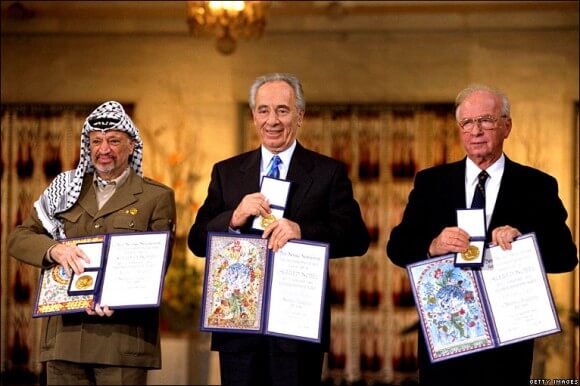Yasser Arafat, Shimon Peres and Yitzhak Rabin after winning the Nobel Peace Prize in 1994. (Photo: Getty Images)