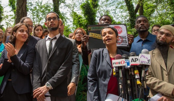 The ACLU is battling the NYPD over its surveillance program targeting Muslims. Above, the ACLU's Hina Shamsi announces the lawsuit alongside plaintiffs in June. (Photo via ACLU)