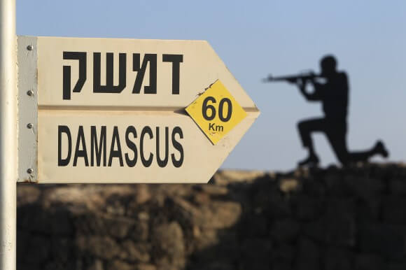 Sign showing the distance to Damascus and a cut out of a soldier at Mt. Bental in the occupied Golan Heights, overlooking Syria. (AP Photo/Tsafrir Abayov via Oxfam)