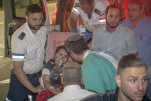 Noam Glick, 9, is taken to a Jerusalem hospital after being shot in Psagot, a Jewish settlement. (Emil Salman / Associated Press / October 5, 2013)