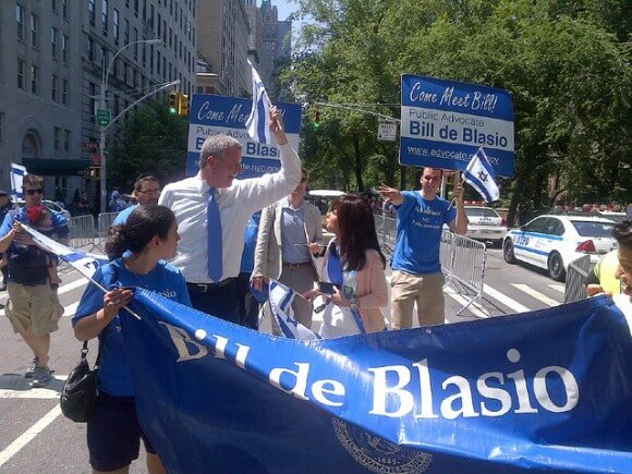 Mayoral candidate Bill de Blasio waves the Israel flag at the 2013 Celebrate Israel parade. (Photo: Bill de Blasio/Flickr)