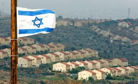 The Israeli flag flying over Israeli settlements in the West Bank (Photo: Reuters)