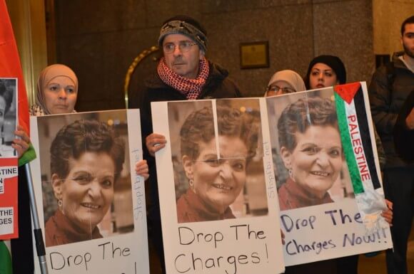Supporters of community activist Rasmea Odeh hold up signs. (Photo via Samidoun.ca)