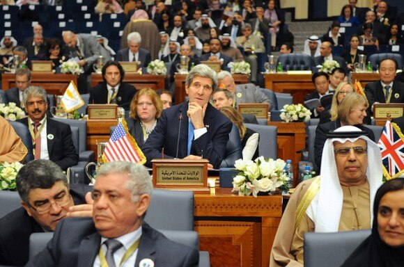 U.S. Secretary of State John Kerry listens at the outset of the Syrian Donors' Conference in Kuwait City , Kuwait, on January 15, 2014