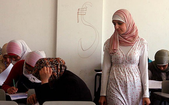 23-year-old software engineering instructor Hadeel Abukwaik (standing) initially lost her Fulbright grant because Israel refused her exit from Gaza.