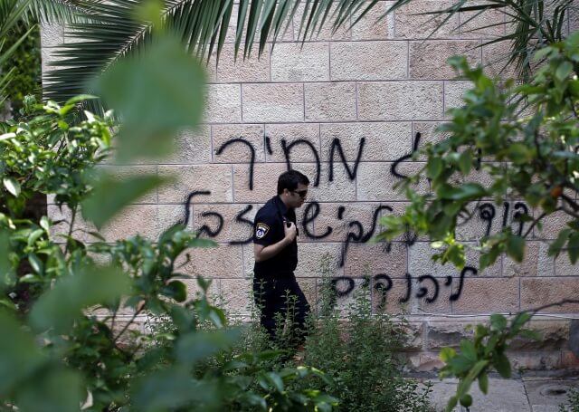 Hebrew graffiti on a Roman Orthodox Church in Jerusalem reads: ‘King David, king of the Jews and Jesus is garbage’. May,9, 2014 (Photograph: Thomas Coex/AFP/Getty Images)