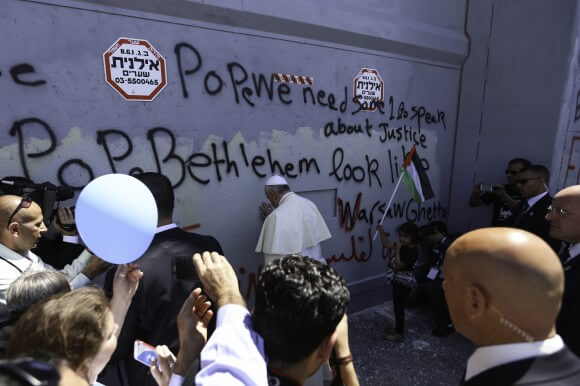 Pope Francis prays at the military gate in the Israeli built Apartheid Wall on May 25th, 2014. (Photo: Kelly Lynn) 