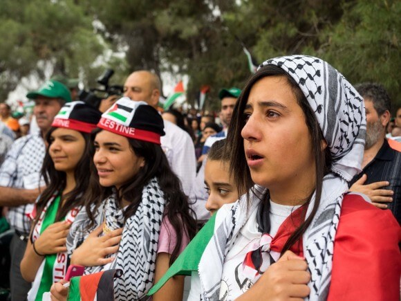 Palestinian girls sing the national anthem. (Photo: Dan Cohen)