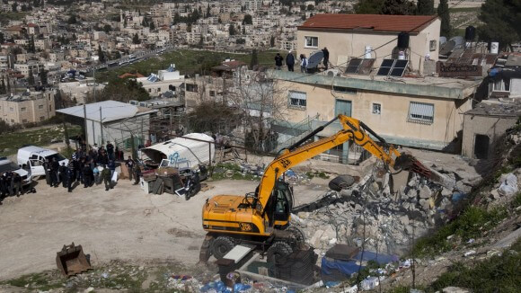 A bulldozer demolishes a Palestinian home in Jerusalem in February 2012. (Photo: Ahmad Gharabli/AFP/Getty Images)