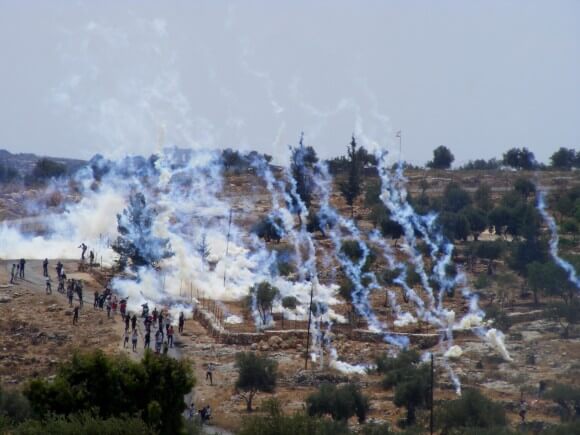 Teargas canisters raining down on Bil'in demonstrators. (Photo: Hamde Abu Rahmah)