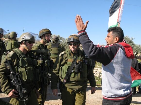 Iyad Burnat speaking to Israeli soldiers in Bil'in (Photo: Haitham Katib)