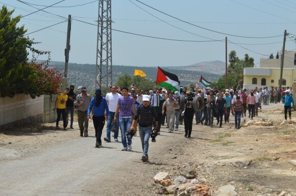 Villagers march towards the Nablus road, blocked by the army since 2003. (Photo: Matthew Vickery)