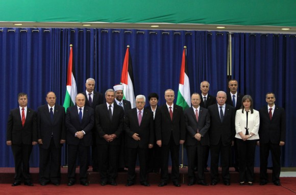  Palestinian President Mahmud Abbas, center, poses for a photograph with the members of the new Palestinian unity government in the West Bank city of Ramallah today. (photo: Abbas Momani/AFP via Getty Images )
