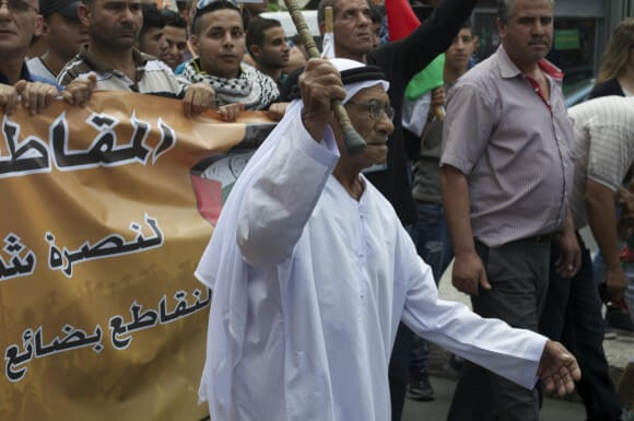 An elder leads daytime protests in Ramallah. (Photo: Sheren Khalel)
