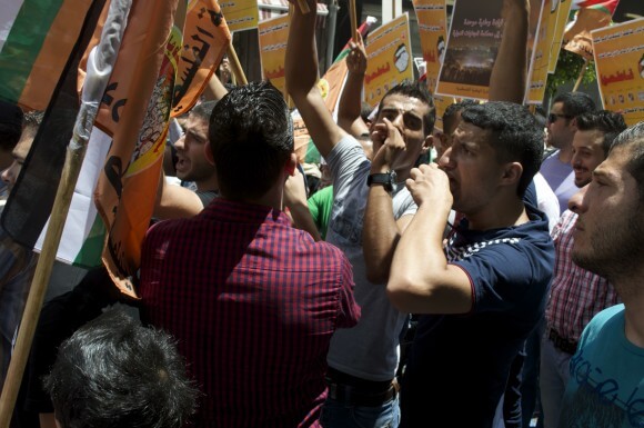 Young men chant at Ramallah's daytime protest in the city center. (Photo: Sheren Khalel)
