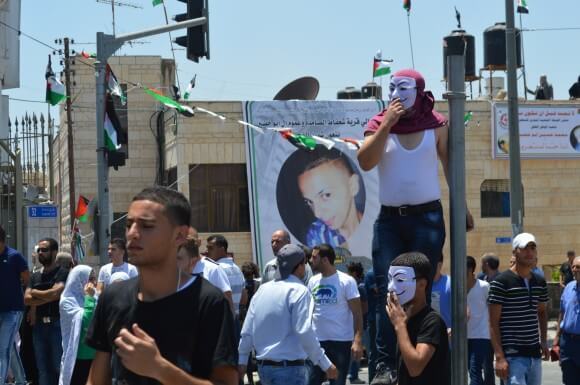 Large crowds gather on Shufat's main street, waiting the arrival of Abu Khdeir's remains. (Photo: Matthew Vickery)