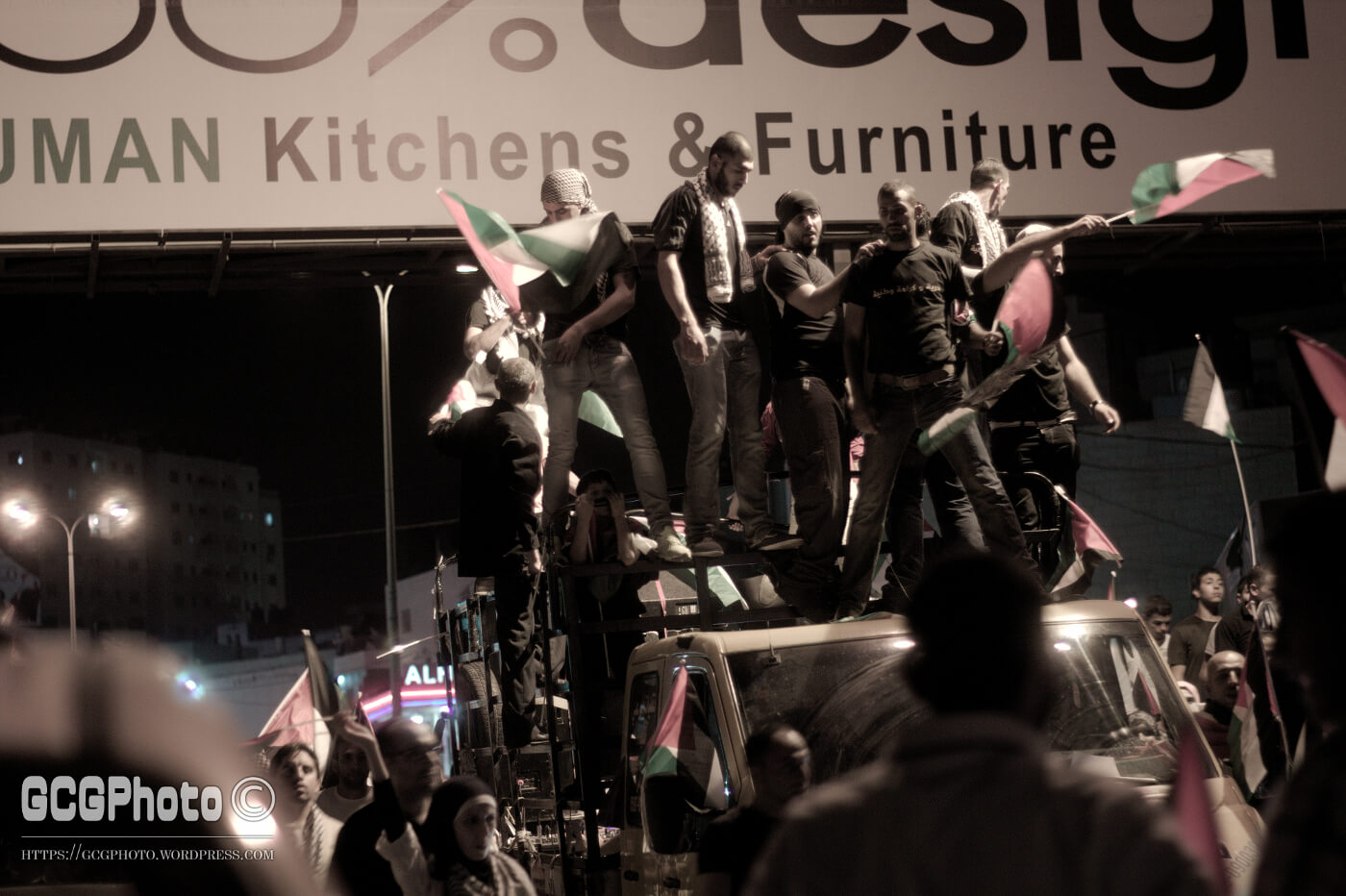 Demonstrators on a truck on its way from downtown Ramallah to Qalandyya. (Photo: Guglielmo Grandinetti)
