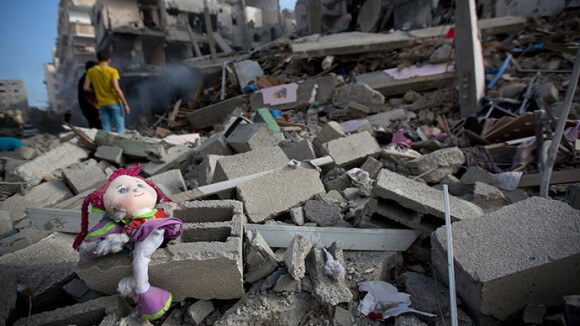 A Palestinian doll lies on the rubble of a destroyed building following an Israeli air strike in Gaza City on July 11, 2014 (AFP Photo / Mohammed Abed)