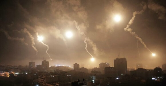 Israeli forces' flares light up the night sky of Gaza City on early Tuesday, July 29, 2014. (AP Photo/Khalil Hamra)