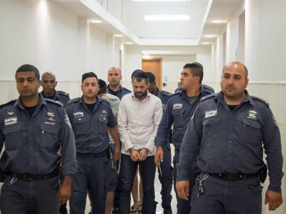 Yosef Chaim Ben David is escorted to the courtroom. (Photo: Dan Cohen)
