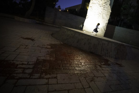 Children play in front of the Israeli Supreme Court with the ground splashed in fake blood after activists filmed their version of the Blood Bucket Challenge. (Photo: Kelly Lynn)