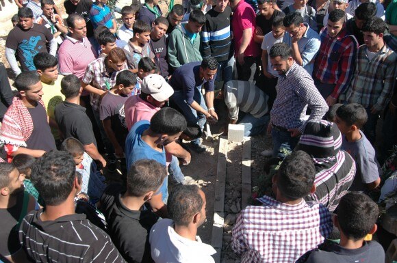 Palestinians mourn Orawah Hammad at a cemetery in the West Bank town of Silwad. (Photo: Allison Deger)
