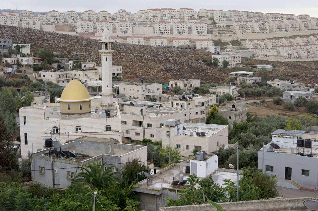 The town of Wadi Fuqin, with a population of 1,300, is dwarfed by the nearby settlement of Beitar Illit, which is home to 60,000 ultra-Orthodox Jewish Israelis. (Photo: Andrew Lichtenstein)