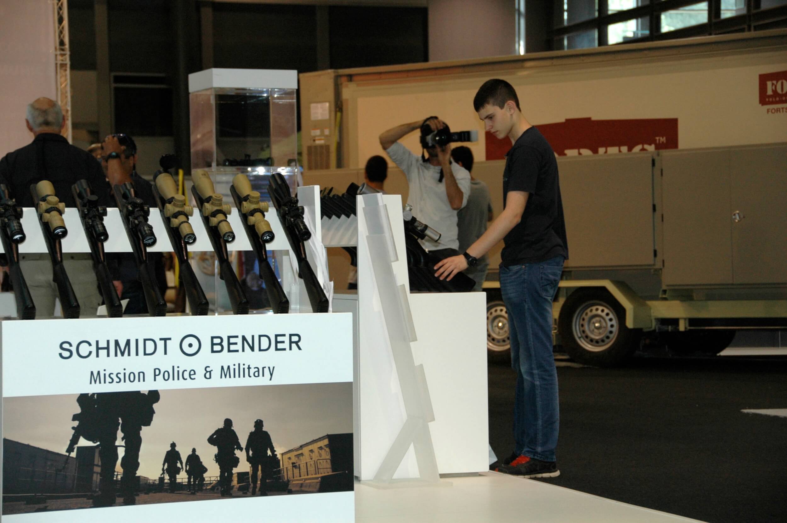 A young man tries out various guns. (Photo: Sarah Levy)
