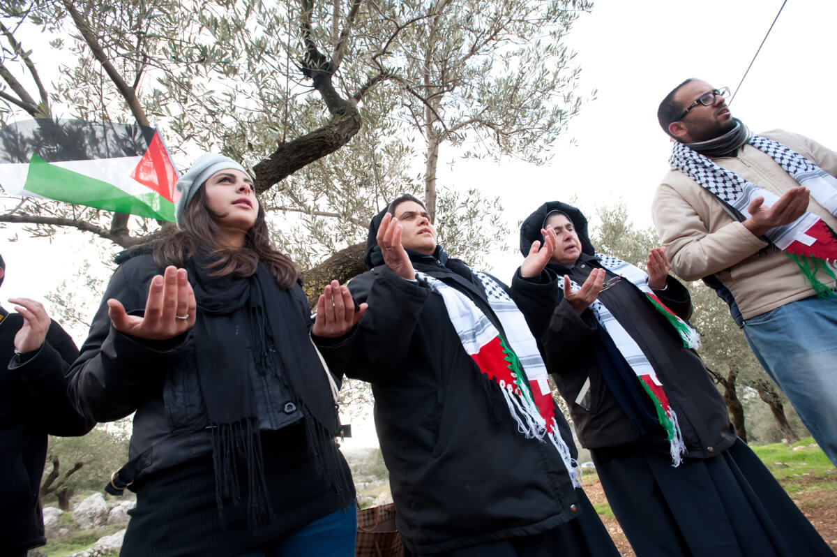 Palestinians hold a prayer service as a nonviolent witness against the Israeli separation barrier in the West Bank town of Beit Jala, Feburary 10, 2012. (Photo: Ryan Rodrick Beiler)