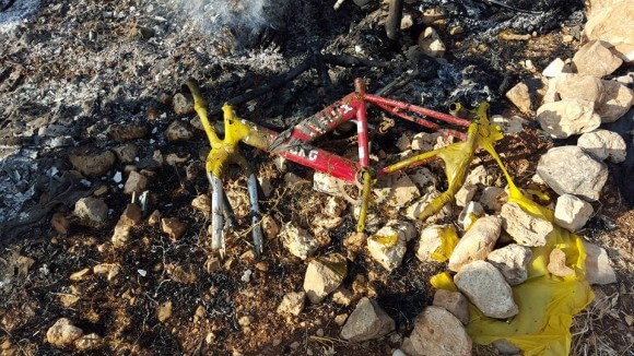 Charred bicycle inside of burned Bedouin tent. (Photo: Zakaria Sadah/Rabbis for Human Rights)