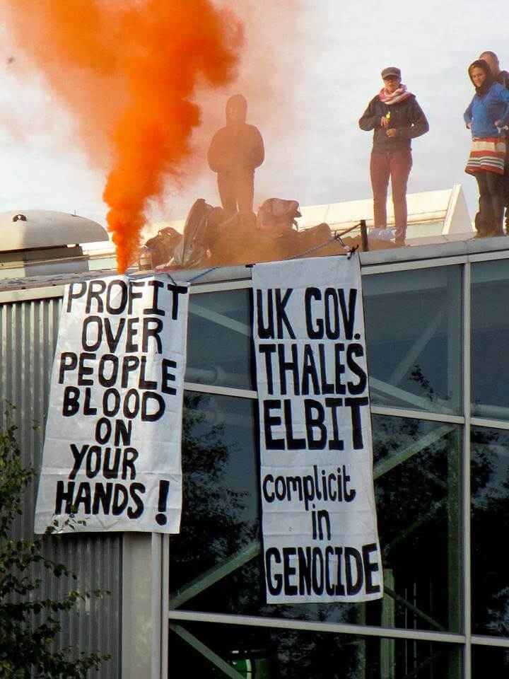 Protesters on the roof of the Thales factory.