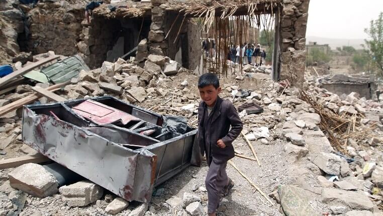 A Yemeni boy walks past the rubble of homes destroyed by Saudi airstrikes. (Photo: AFP / Mohammed Huwais)