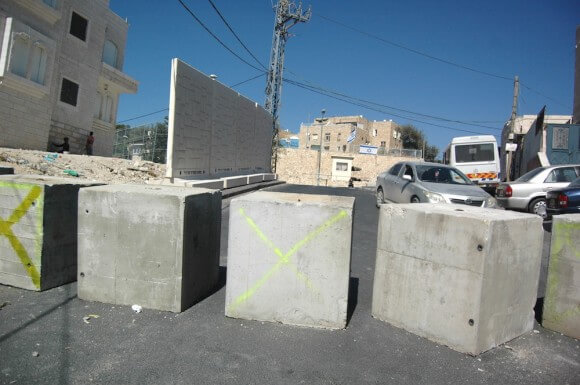 Israel's latest security measures place roadblocks, a wall, and a checkpoint in the Jabel Mukaber neighborhood of East Jerusalem. (Photo: Allison Deger)