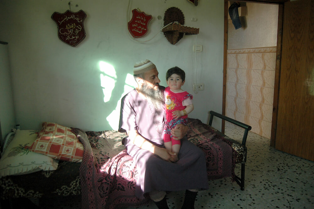 Mohammed Makhamri, in his son Khaled's bedroom, Yatta. (Photo: Allison Deger)