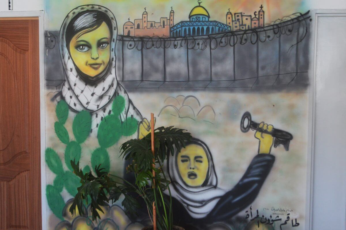 A mural highlighting the Palestinian people's belief in the Right to Return and the importance of the Al-Aqsa Mosque inside the Sair Municipality building. (Photo: Sheren Khalel)