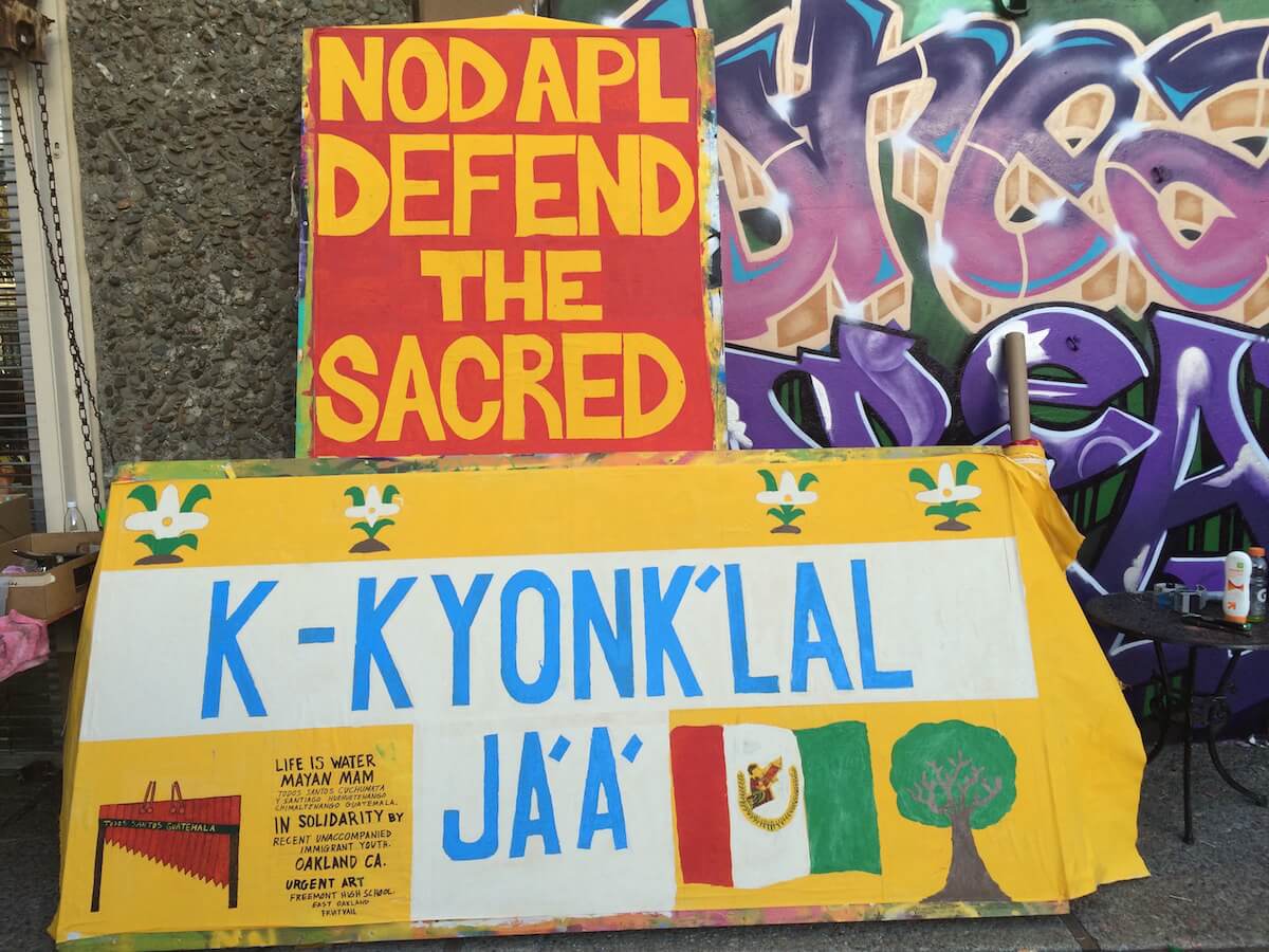 Art build in Oakland, CA : Recent unaccompanied minors from Guatemala write “Water is Life” in Maya. (Photo: Nadya Tannous)