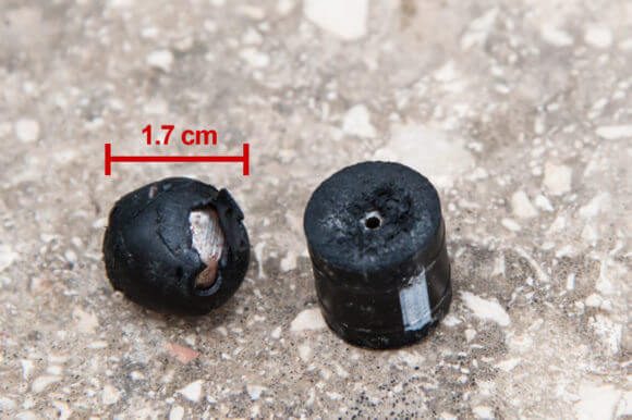 Examples of coated steel bullets used by Israeli forces. One is a steel ball covered in a very thin, hard, material, more like plastic. The other is a softer rubber cylinder shape, but also has a steel core. Both are typically fired from an adapter fitted to the barrel of an M16 assault rifle. (Photo: Ryan Rodrick Beiler)