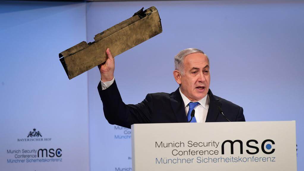 Netanyahu brandishes wreckage he says came from an Iranian drone in Israeli air space, Feb. 18, 2018, at a Munich security conference.