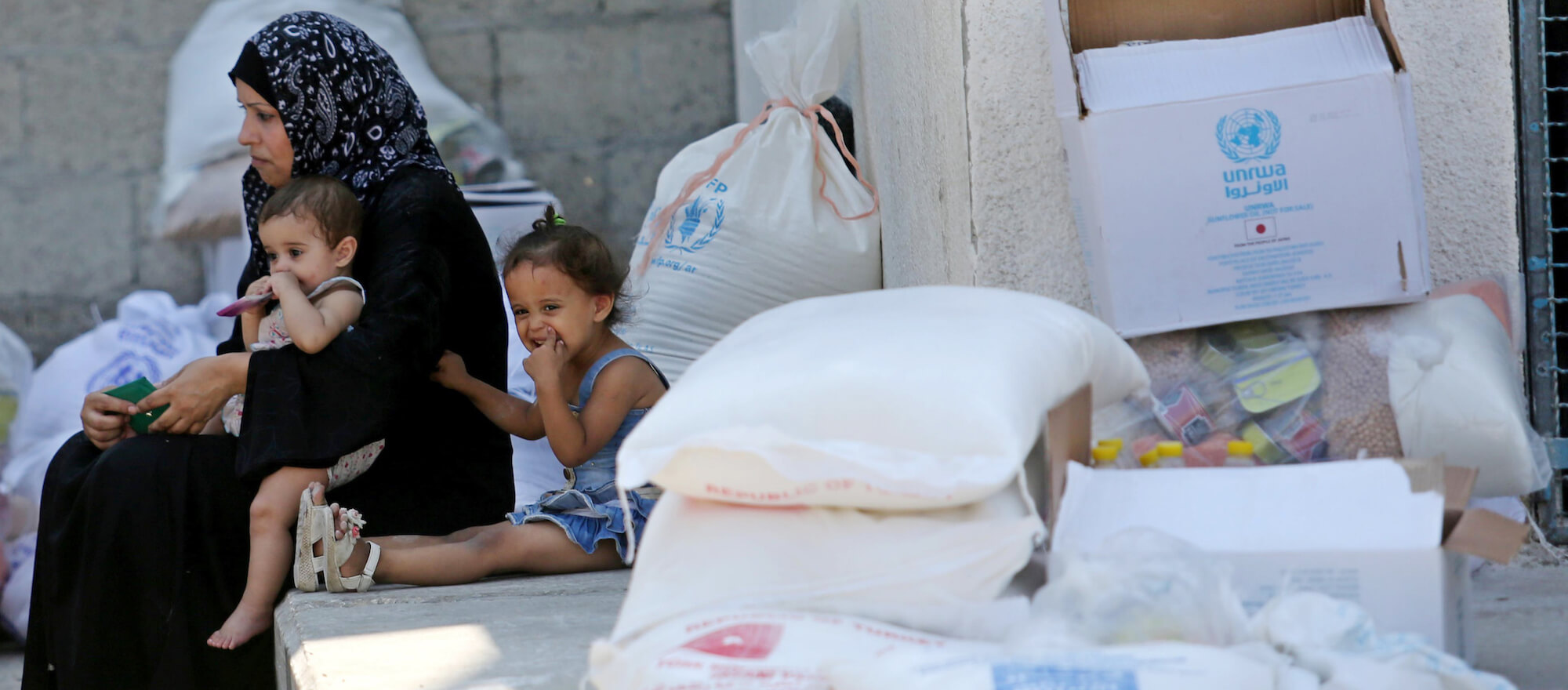 Palestinians receive food aid at an aid distribution center run by United Nations Relief and Works Agency (UNRWA) in Khan Younis in the southern Gaza Strip on September 4, 2018. The United States halted all funding to United Nations' agency that helps Palestinian refugees. State Department spokeswoman Heather Nauert said the business model and fiscal practices of the United Nations Relief and Works Agency (UNRWA) made it an ìirredeemably flawed operation. (Photo: Ashraf Amra/APA Images)