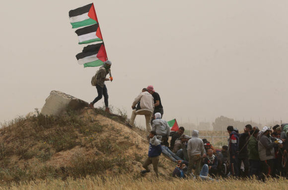 Palestinian protesters join the Great March of Return at the Israel-Gaza border in Khan Younis in the southern Gaza Strip