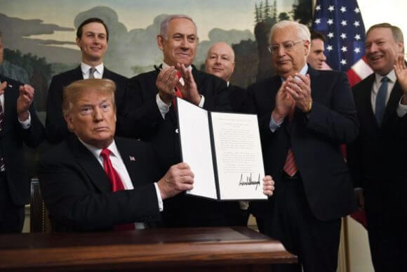 President Donald Trump holds up an executive proclamation recognizing the Golan Heights as Israeli territory at the White House in Washington DC, Monday, March 25, 2019. (Photo: Susan Walsh/AP)